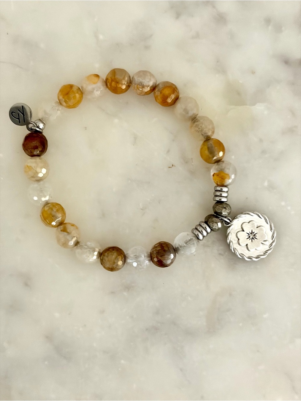 Hand crafted with semi precious stones and a sterling silver charm.
